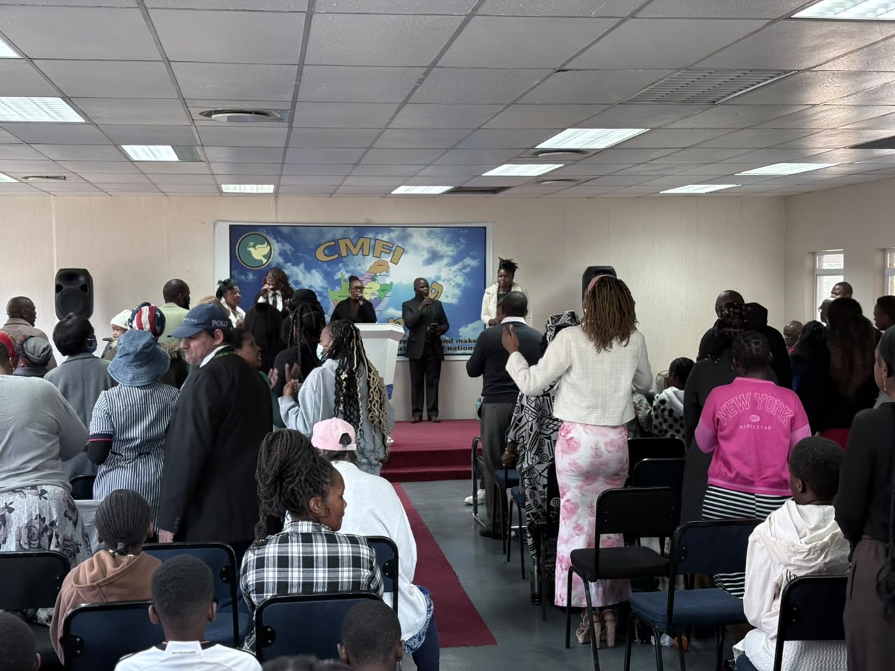 Congregation worshipping together during a CMFI SA service