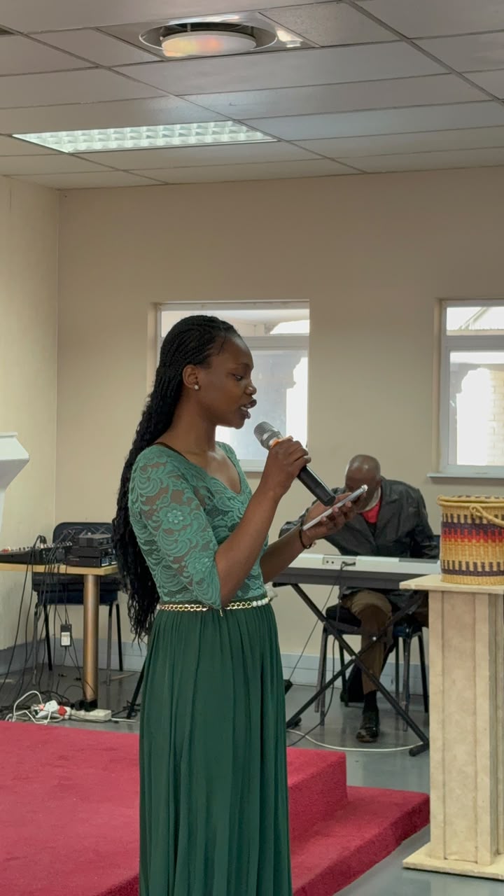 A worship leader singing on stage